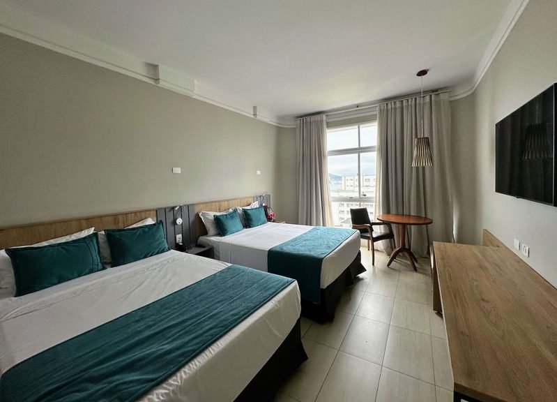 suíte do Hotel Parque Balneário Santos com 2 camas de casal